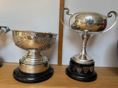 Raymond Baxter Trophy on left. Showing Height 20cm on ebony base. Trophy on right is Vice Presidents Trophy