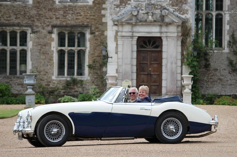 Dave and Angela in their 1963 Austin Healey 3000 Mk11 BJ7 outside Loseley Hall near Guildford